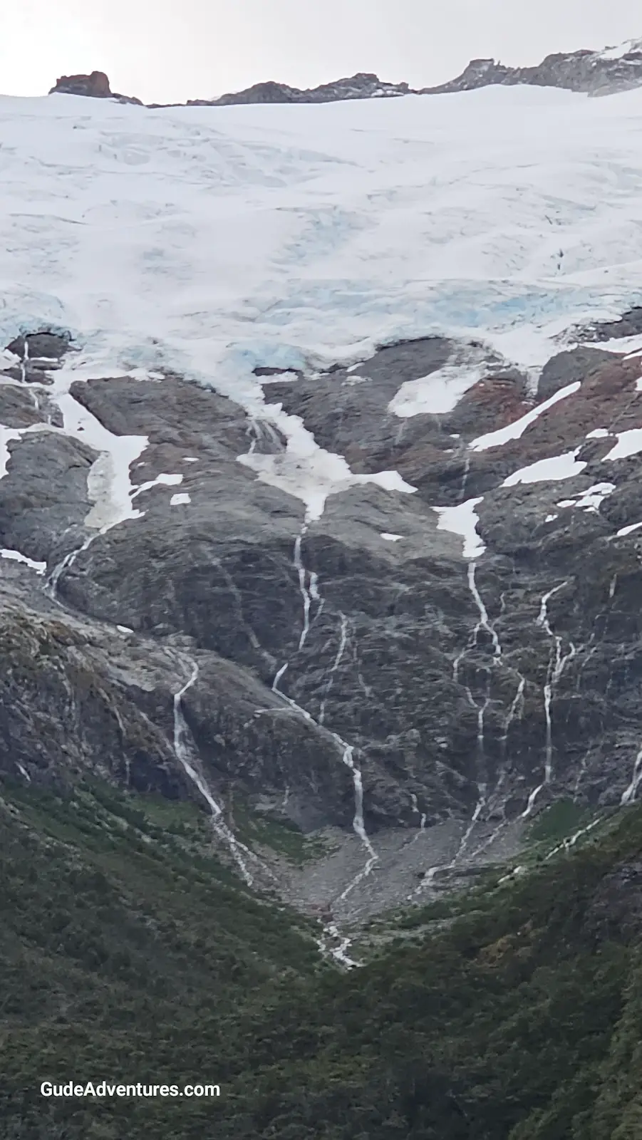 Waterfalls down from a glacier on the shore of the Beagle Channel