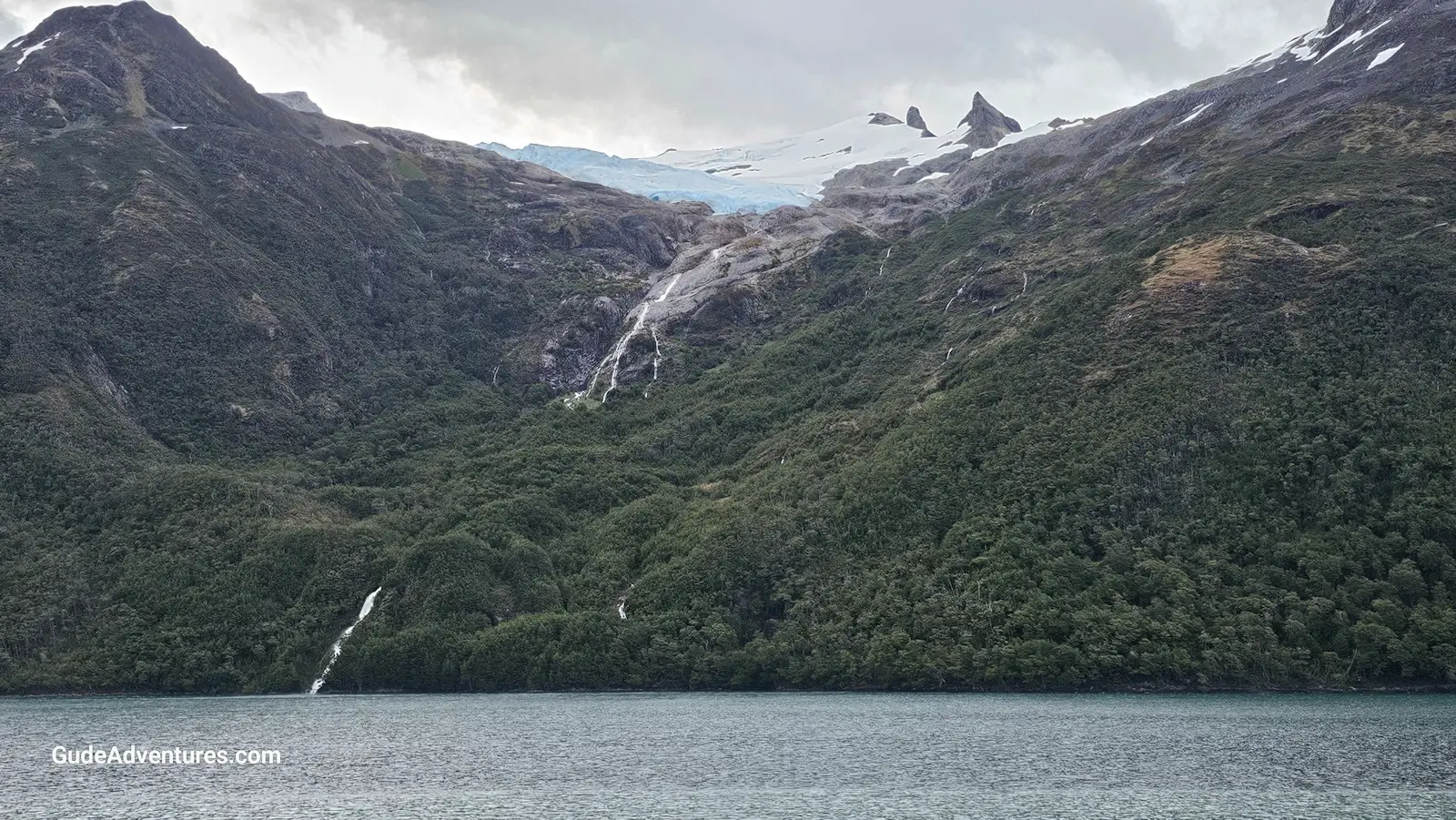 Waterfall coming down from a glacier to the shore of the Beagle Channel