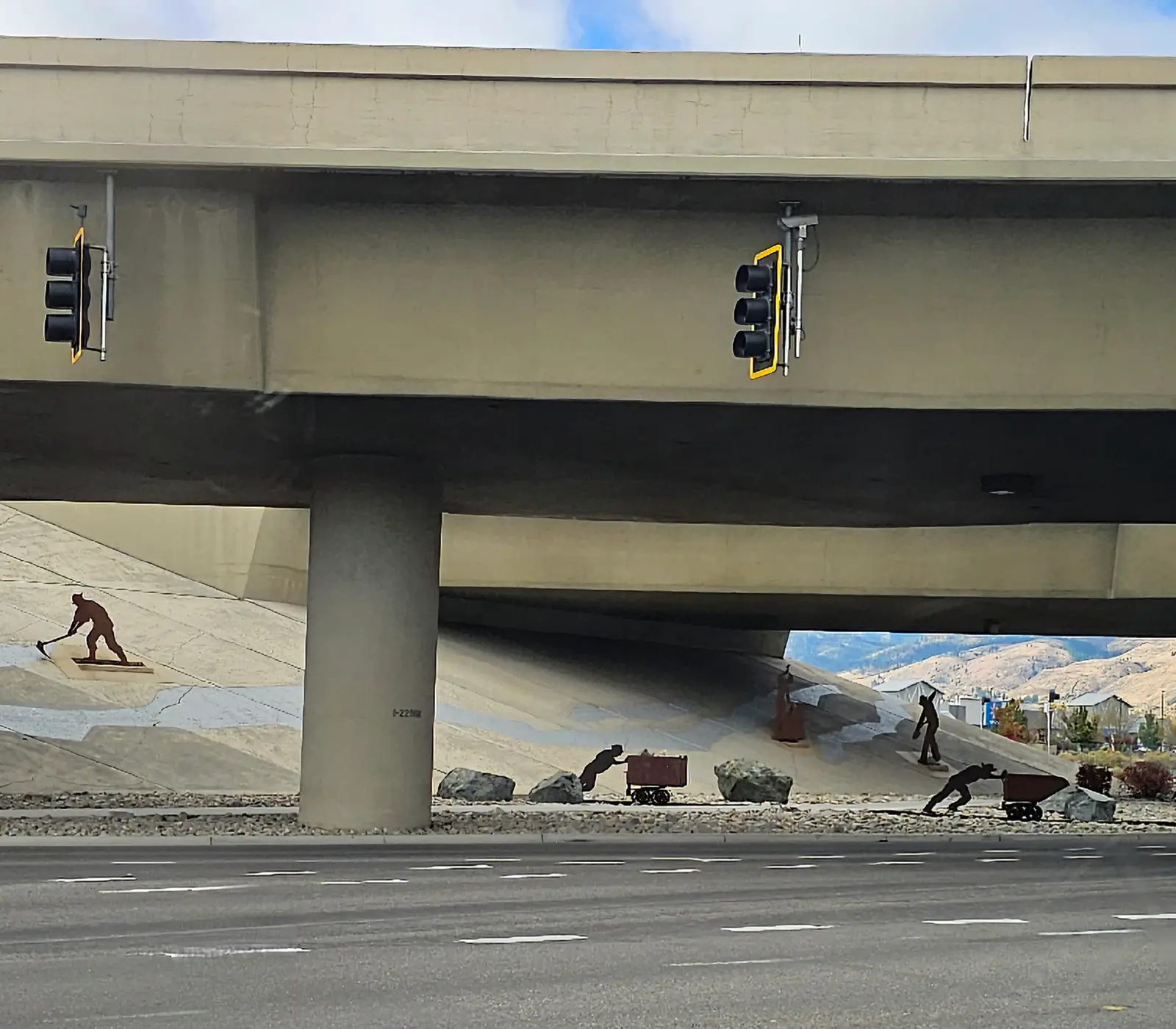 Mining history sculpture under the highway bridge