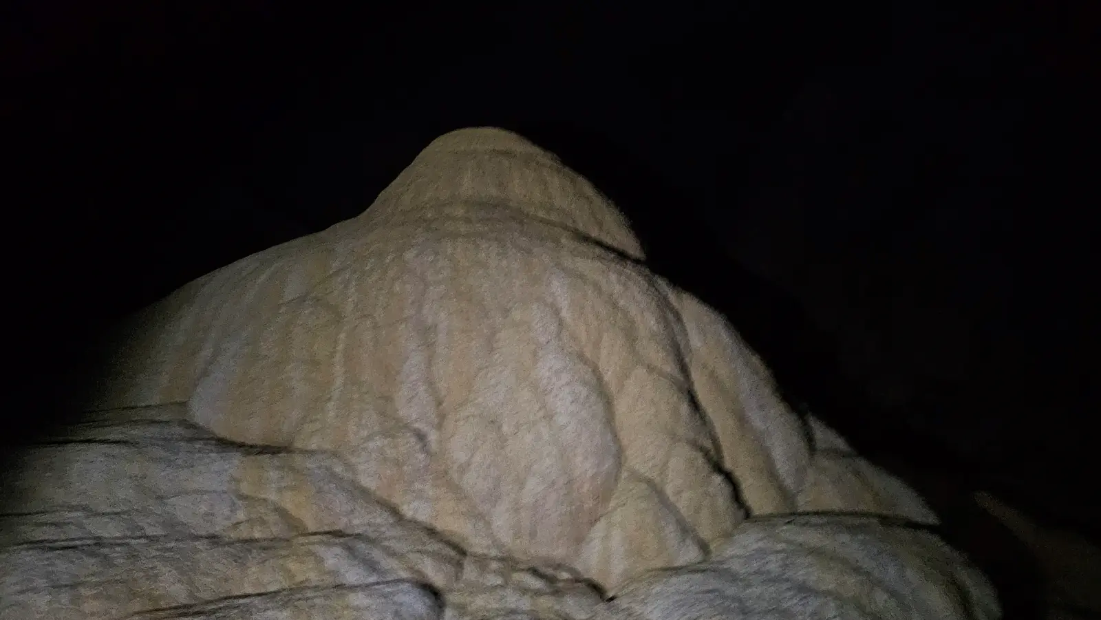This stalagmite is forming under an opening in the roof of the cave which creates a waterfall over it when it rains.