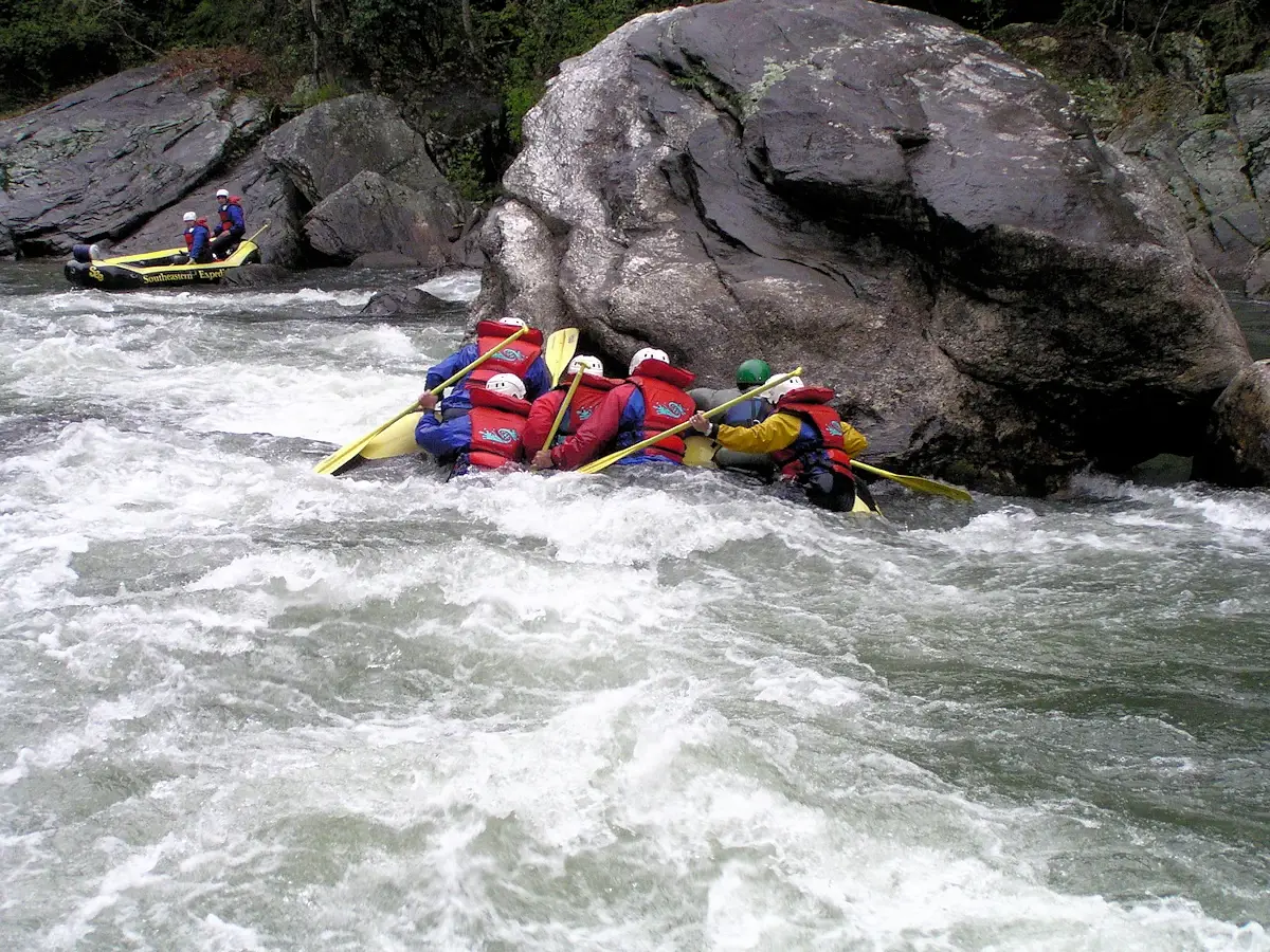 Hitting the rocks while whitewater rafting on the Chattooga River rapids 