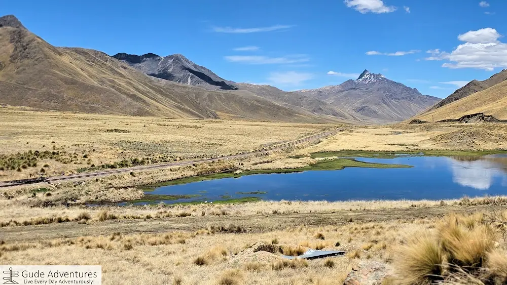 The Cusco–Puno railway passing thru the La Raya Pass and headwaters of the Ramis River as it flows to Lake Titicaca