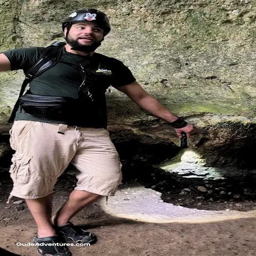 Guide pointing out a petroglyph in the Light Cave.