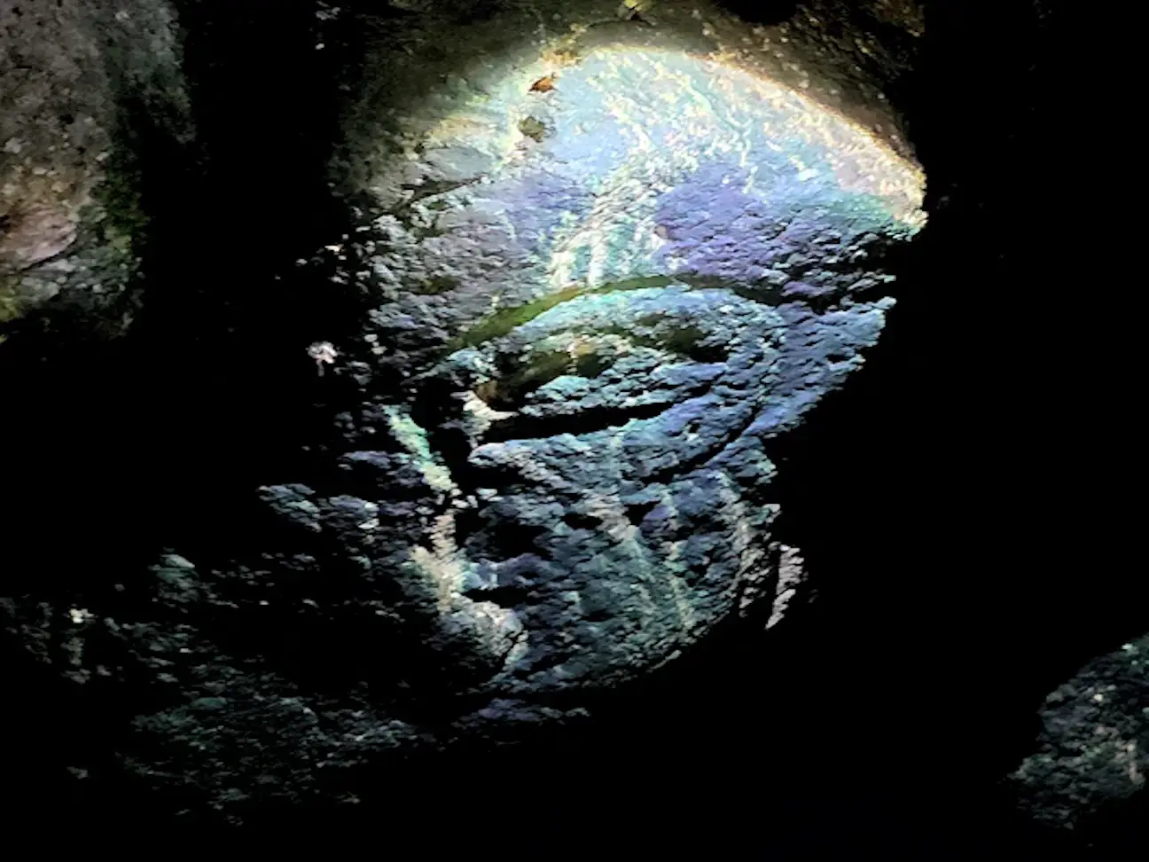Ancient Taino petroglyph on one of the stalactites in the cave.