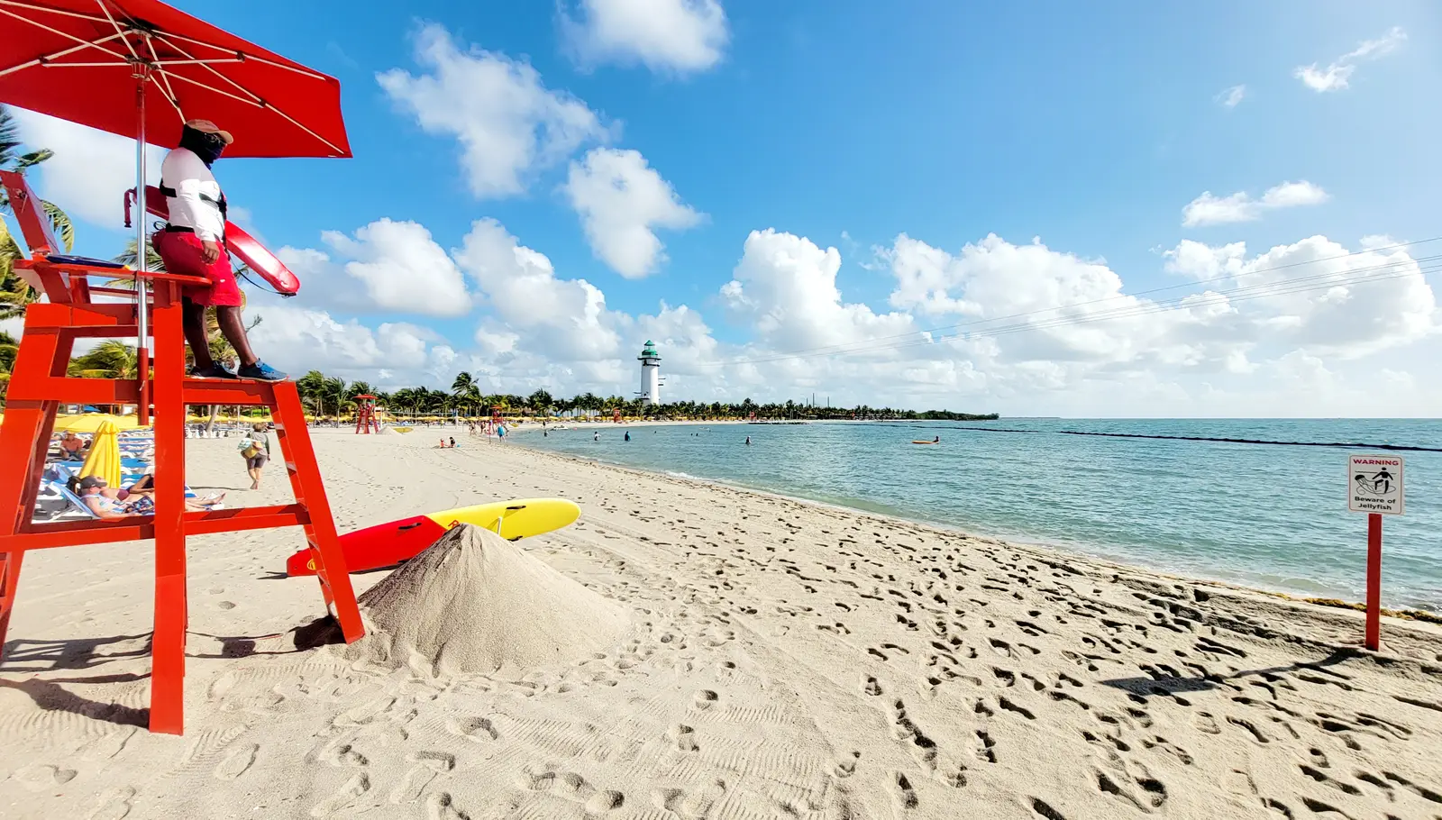 The beach and lighthouse at Harvest Cay.