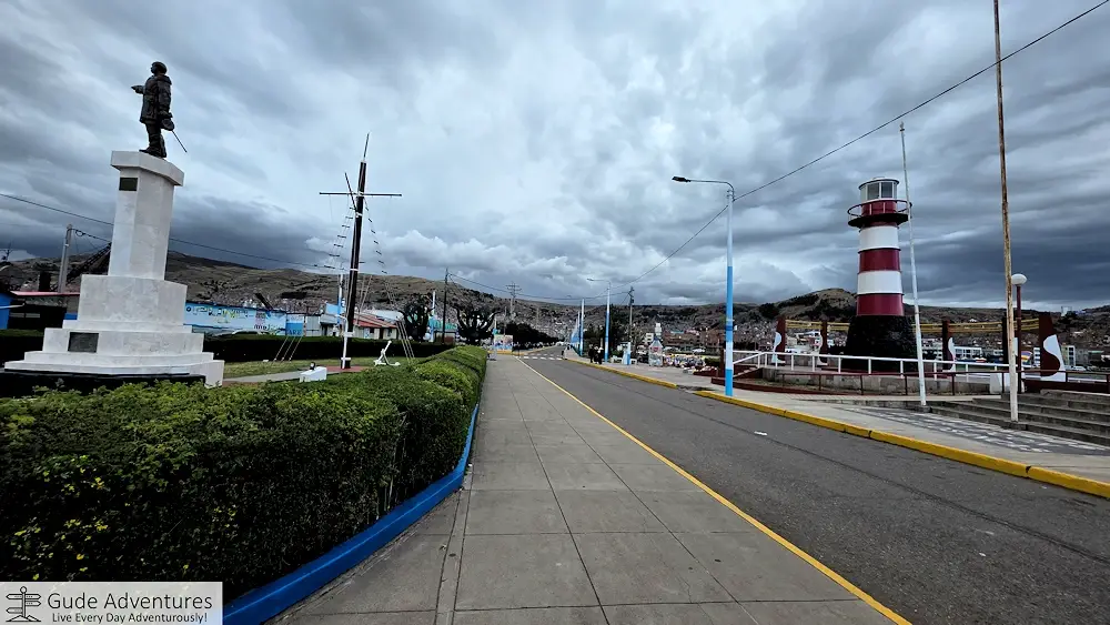 Statue and lighthouse at the Puno Harbor on Lake Titicaca