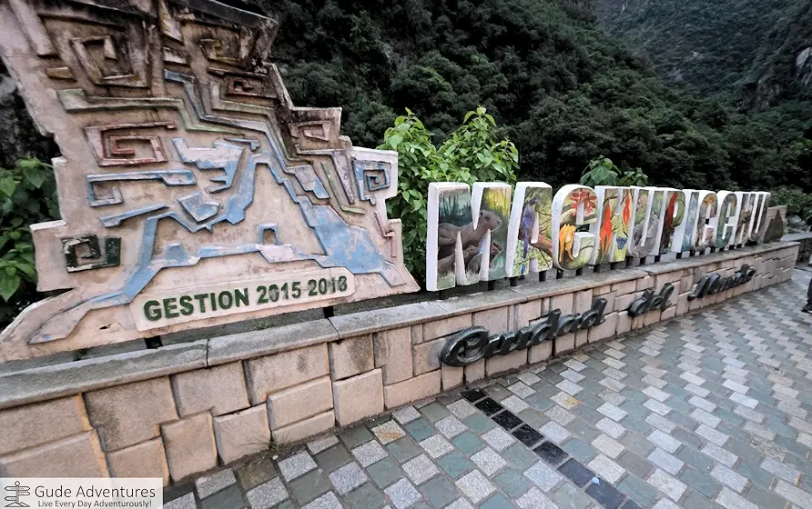 Machu Picchu sign at the base of the mountain