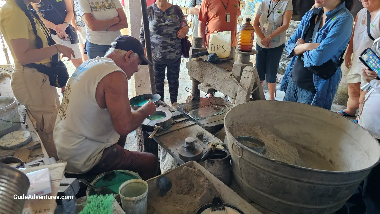 Artisan making painted tiles