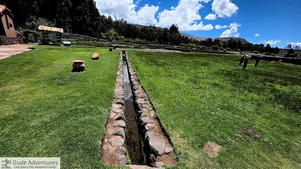 Aqueduct thru the ruins of Raqchi flowing to the village