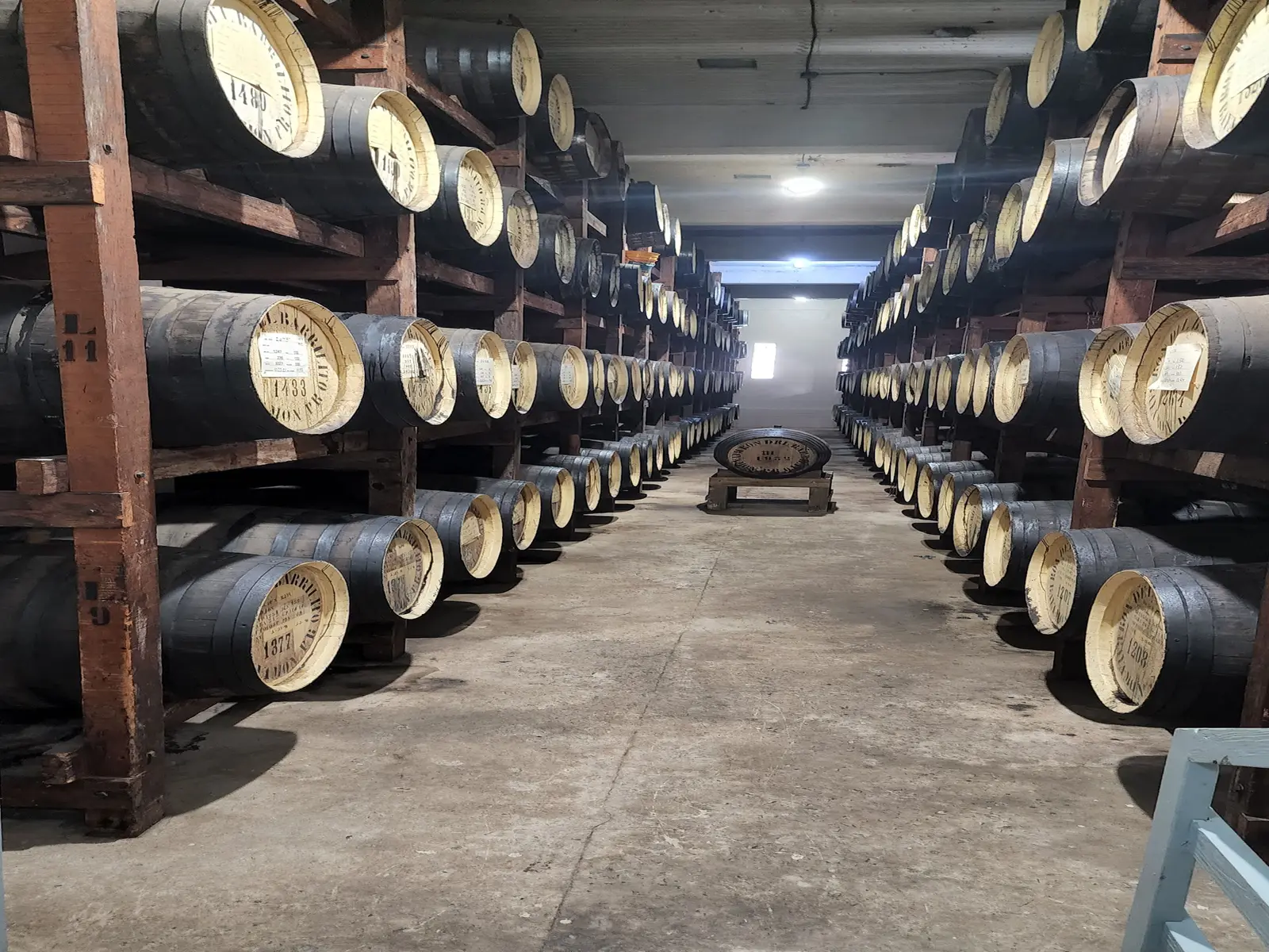 Rows of rum filled barrels are in the aging room.