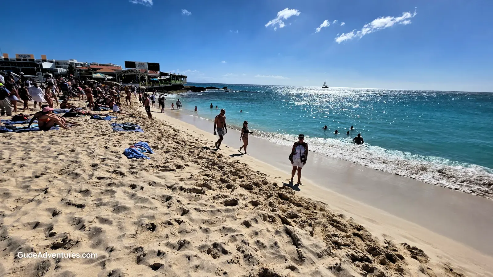 People on Maho Beach watching aircraft landing over their head