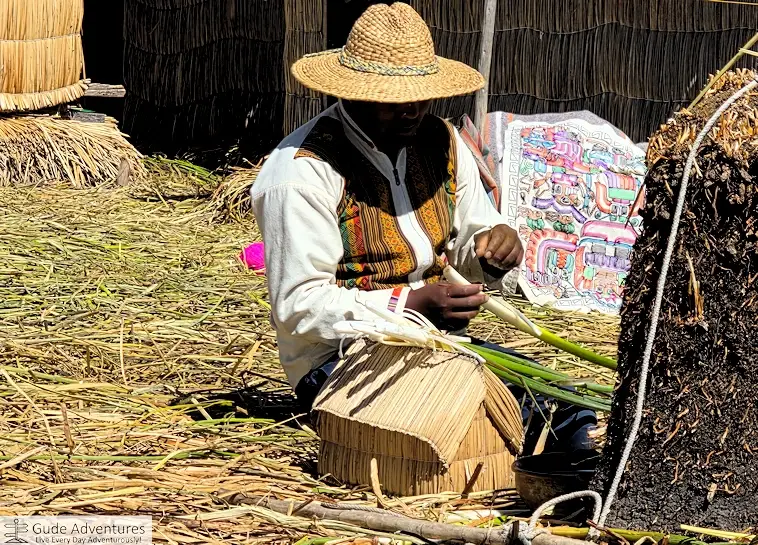 Village chief showing how the reeds can be used for making different things and for food