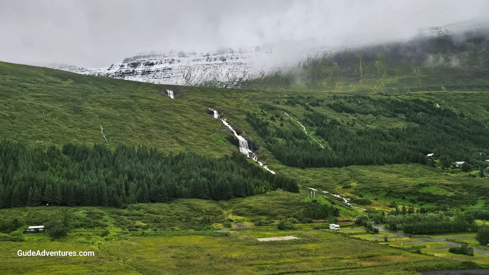 The mountains and the Bunarfoss waterfall between Isafjord and Onumdarfjord.